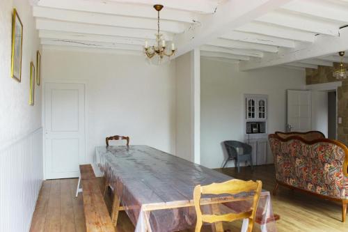 a dining room with a wooden table and chairs at Gîtes pour grand groupe 18 personnes à 15 mins du Puy du Fou in Mauléon