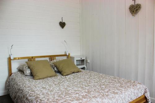 a bedroom with a bed and a white wall at Gîtes pour grand groupe 18 personnes à 15 mins du Puy du Fou in Mauléon