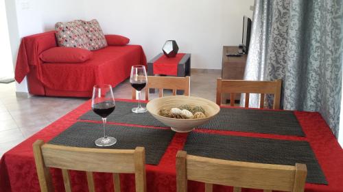 a dining room table with two glasses of wine at Apartment Sevid in Sevid