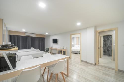 a kitchen and living room with a table and chairs at The Space Hotel Lampang in Lampang