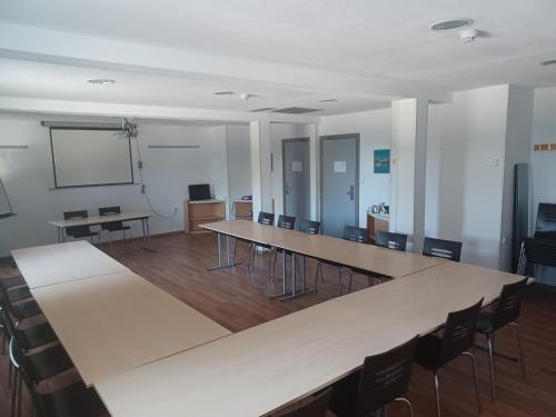 a classroom with tables and chairs and a whiteboard at Ibis Hotel Alicante in Alicante