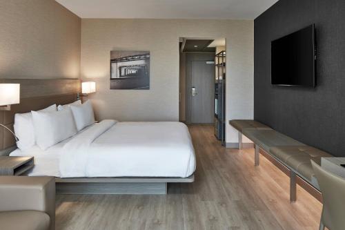 a hotel room with a large bed and a television at AC Hotel Miami Wynwood in Miami