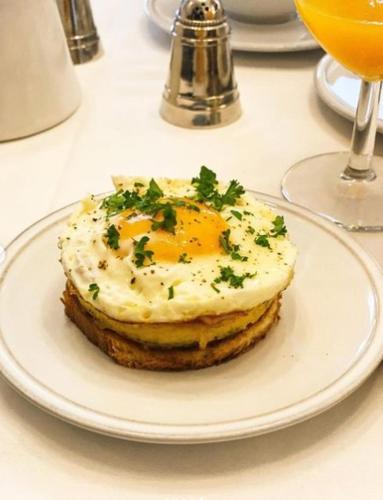 a plate of food on a table with an egg on it at Mansion9Bruges in Bruges