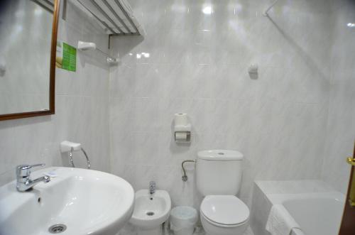 bagno bianco con servizi igienici e lavandino di Hotel Salldemar a Santillana del Mar