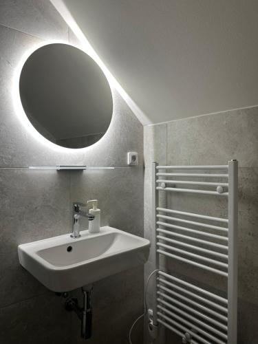 a bathroom with a sink and a mirror at Degustarium Bavory in Bavory