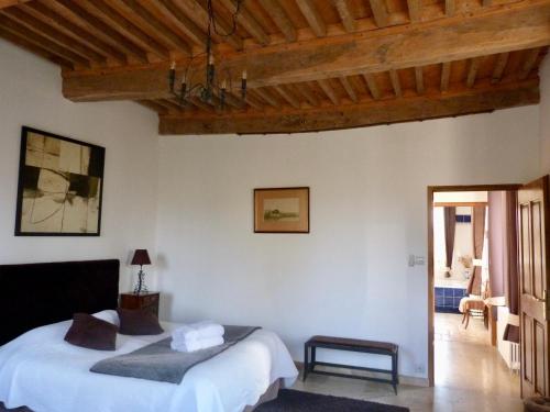 a bedroom with a bed and a wooden ceiling at Domaine du Manoir in Les Avenières