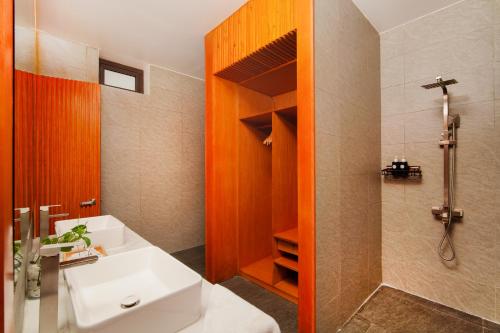 a bathroom with a white sink and a shower at Hola Villa 2 by Ovui in Hiếu Nhơn
