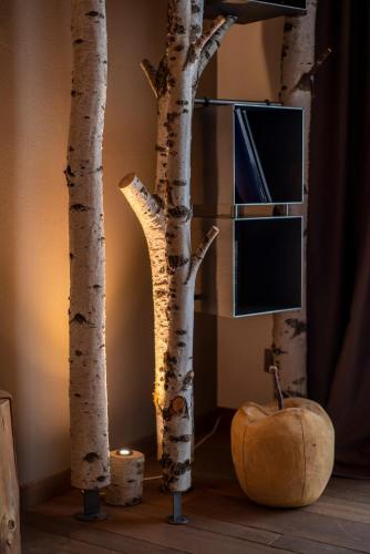a group of birch trees in a room with a pumpkin at Casera Cornolera in Chies dʼAlpago