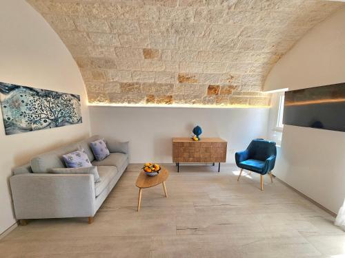 a living room with a couch and a table at IL GELSO BIANCO Luxury apartments in Polignano a Mare