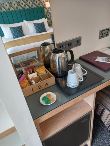 a room with a desk with a tea set on it at The Gatsby Blackpool - Formerly The Windsor in Blackpool