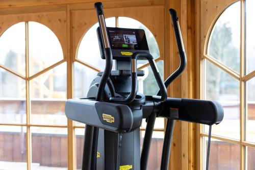 a exercise machine in a room with windows at Wellness Aparthotel "Lechlife" incl Pool - 400m zum LIFT in Reutte