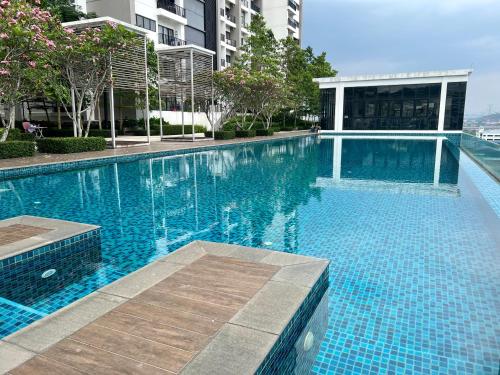 a large blue swimming pool in a building at Cozy Studio Sk 1 Residence for 4 pax UPM Mines Serdang in Seri Kembangan