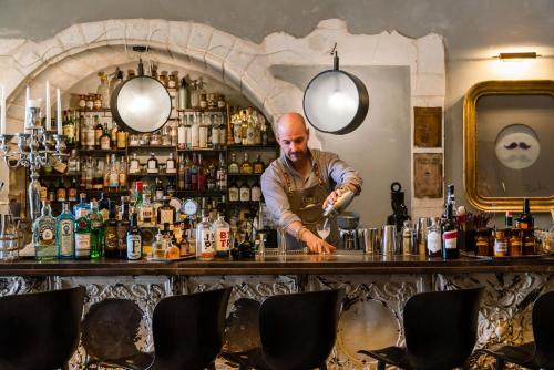 a man standing behind a bar in a pub at Paragon 700 Boutique Hotel & SPA in Ostuni