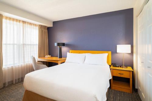 a hotel room with a large bed and a desk at Residence Inn Southington in Southington