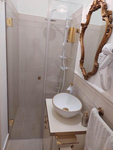 a bathroom with a sink and a shower at Zati Suite in Budapest