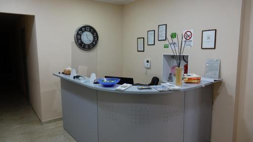 a counter in a room with a clock on the wall at Cairoli Exclusive Rooms & Suite in Brindisi