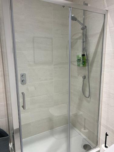 a shower with a glass door in a bathroom at 39 Teesra House in Plymouth