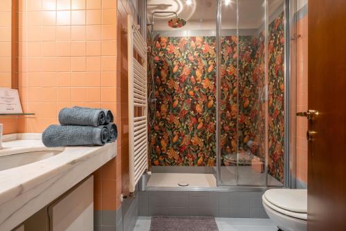 a bathroom with a shower and a toilet at Casa Flavia ai Morosini - Luxury apartment with Canal View in Venice