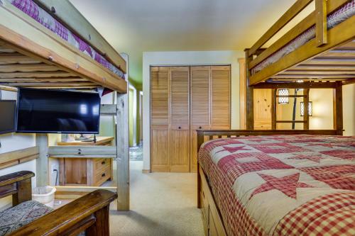 a bedroom with two bunk beds and a flat screen tv at Winter Park Condo Rental about 2 Mi to Ski Resort! in Winter Park
