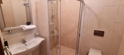 a bathroom with a shower and a toilet and a sink at Eve Santa Marina Studios - sea, pools, relax in Sozopol