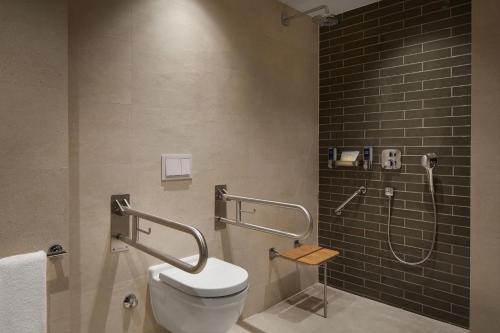 a bathroom with a toilet and a shower at Four Points by Sheraton Prishtina City in Prishtinë