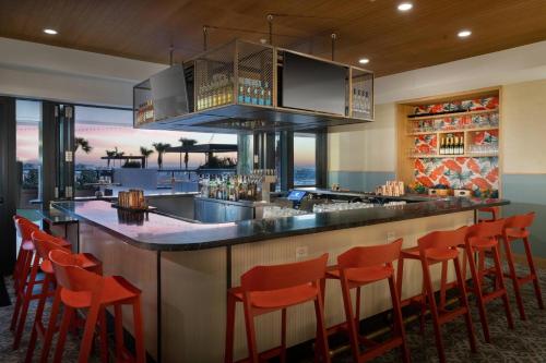 a bar with orange chairs at a restaurant at JW Marriott Tampa Water Street in Tampa