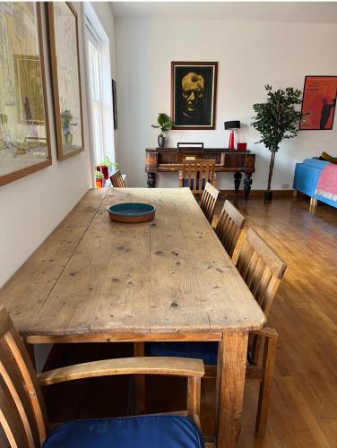a dining room with a wooden table and chairs at Charming City Townhouse in Dublin