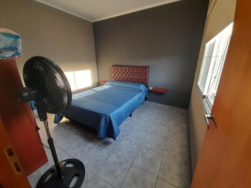 a room with a bed and a fan in it at Complejo EQUE PORA in Federación