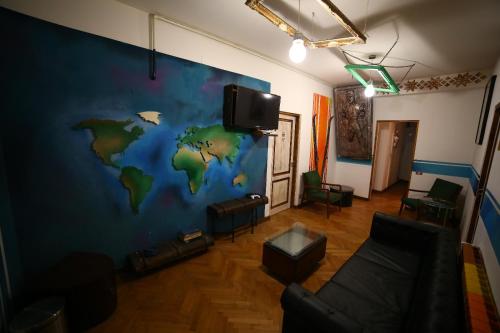 a room with a mural of a world on the wall at Hostel Bauhaus in Bucharest