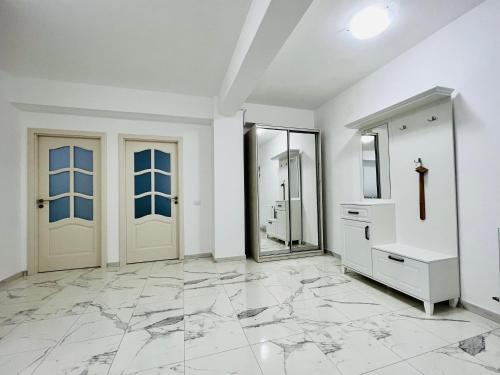 a bathroom with two doors and a marble floor at Altheda Living White House 29F-2 in Suceava