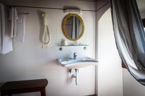a bathroom with a sink and a mirror at Albergo San Lorenzo in Poppi