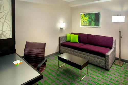a living room with a couch and a chair at SpringHill Suites by Marriott New York Midtown Manhattan/Fifth Avenue in New York