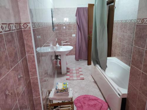 a bathroom with a sink and a toilet and a tub at Bed and Breakfast Oasi in Reggio di Calabria