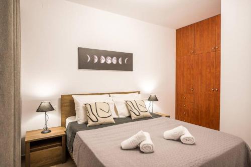 een slaapkamer met een bed met twee handdoeken erop bij Sofman city center apartment I in Heraklion