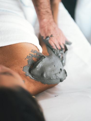 a man painting his knee with a paintbrush at Hotel Terme Millepini in Montegrotto Terme