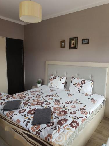 a bedroom with a large bed with two laptops on it at Бадевски рай-къща Вяра in Badewzi