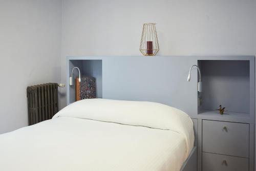 Un ou plusieurs lits dans un hébergement de l'établissement Hotel Le Petit Duquesne