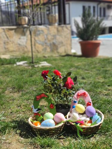 a basket filled with easter eggs and a plant at Бадевски рай-къща Надежда in Badewzi