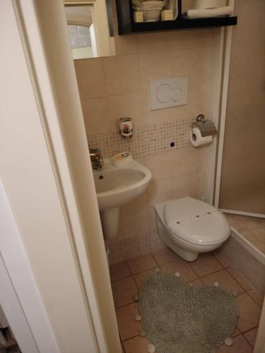 a small bathroom with a toilet and a sink at Casa Dante - Holiday House in Fasano