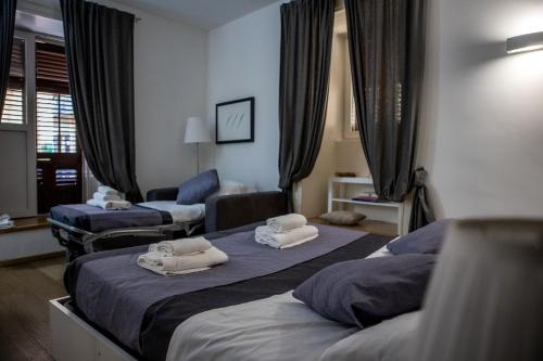 een hotelkamer met 2 bedden en handdoeken erop bij Palermo al Centro - Appartamento Vittorio in Palermo