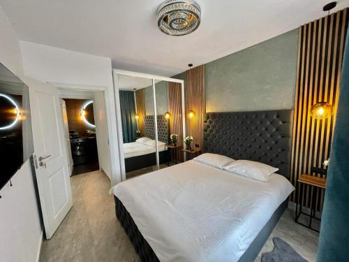 a bedroom with a large bed and a mirror at Aici te simți ca acasa in Iaşi