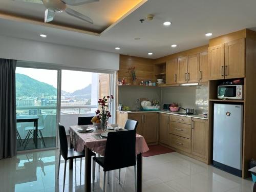 a kitchen with a table and chairs and a kitchen with a view at Patong Beach Top Location in Patong Beach
