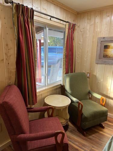 a living room with two chairs and a window at Homestead Inn - Blowing Rock in Blowing Rock