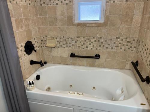 a white bath tub in a bathroom with a window at Homestead Inn - Blowing Rock in Blowing Rock