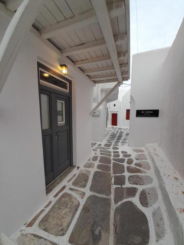 a hallway with a door and a stone walkway at Terra Nova in Mikonos
