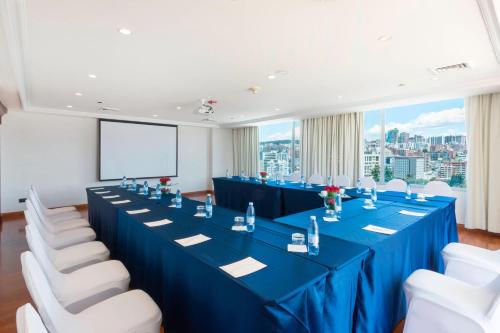 a conference room with blue tables and white chairs at JW Marriott Quito in Quito