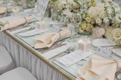 a table with white flowers and silverware on it at JW Marriott Quito in Quito