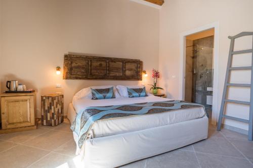 a bedroom with a large white bed in a room at Moon's Tower suite&rooms in Portoscuso
