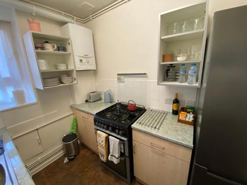 a kitchen with a stove and a counter top at 3 Bed apartment in Camden in London