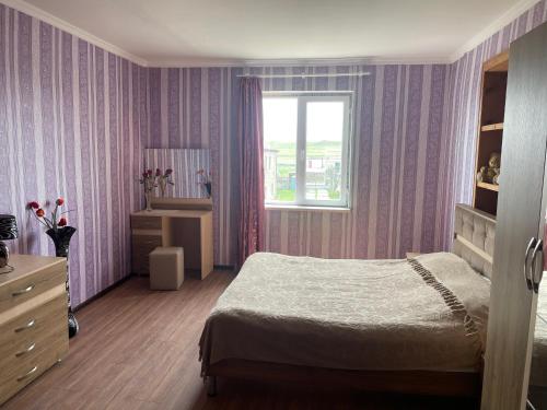 a bedroom with a bed and a window at wine valley in Udabno